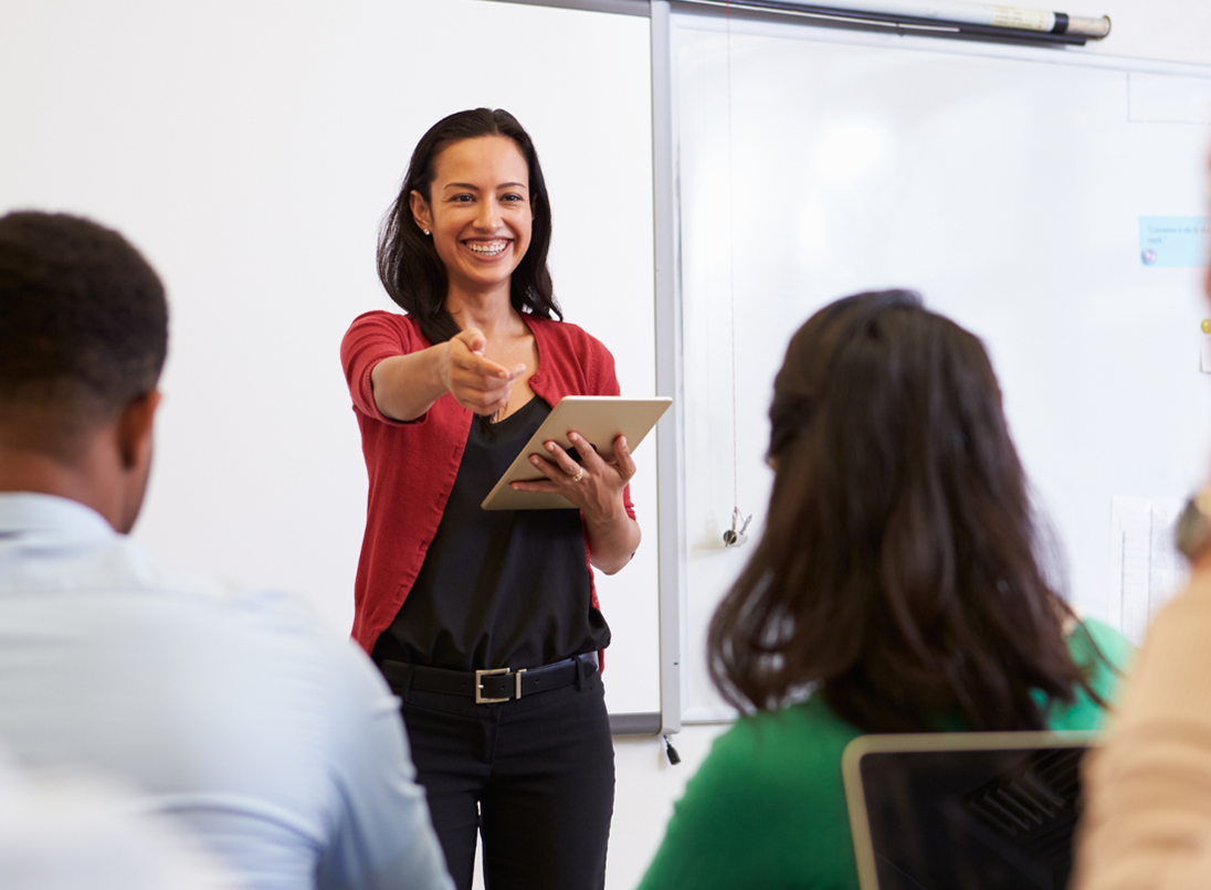 Picture of school teacher performing lesson to students